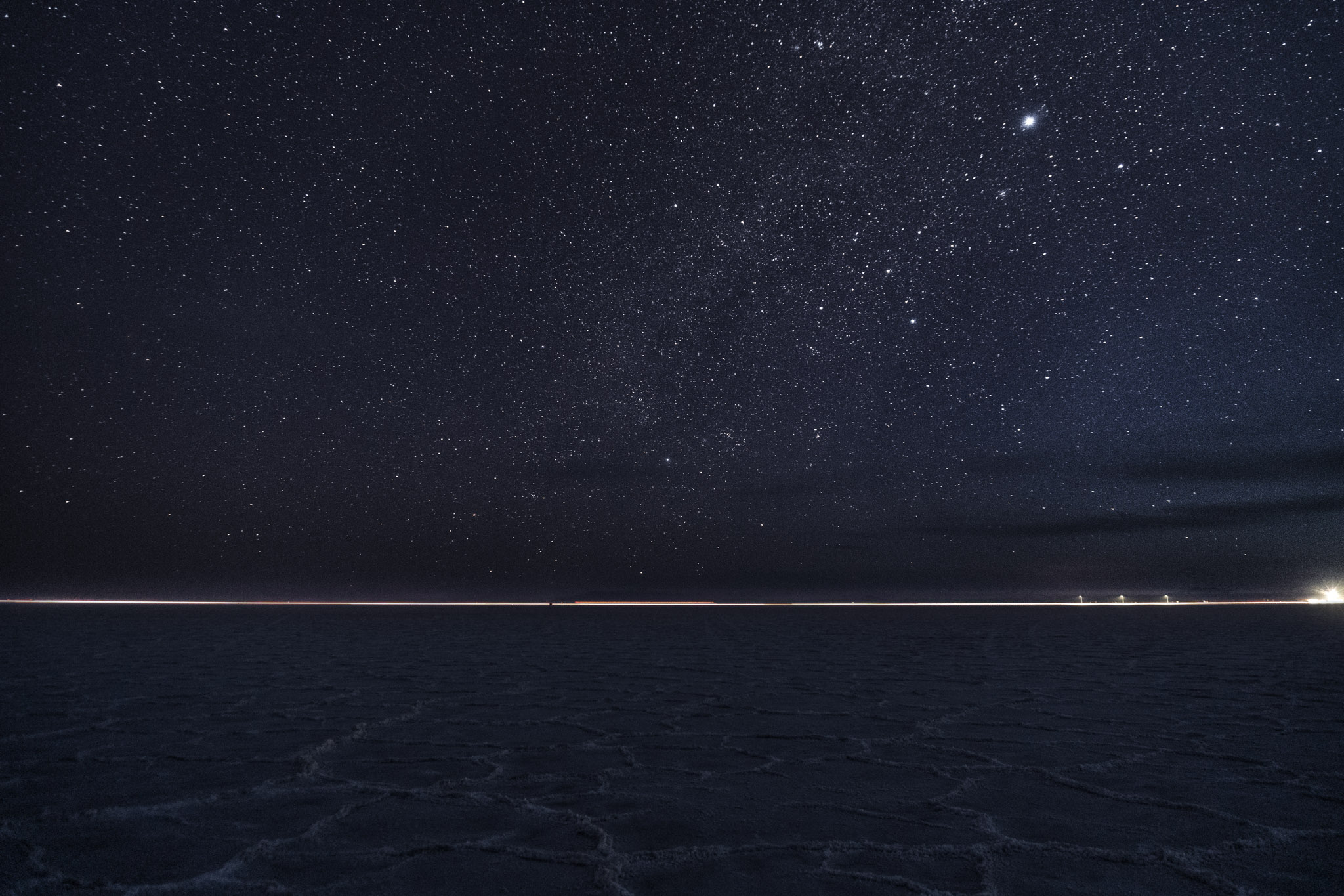 Nearly black starry sky with just as dark textured salt flats